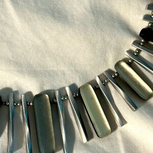 Necklace made of carved lucite. Goes well with crewneck shirts and button downs.